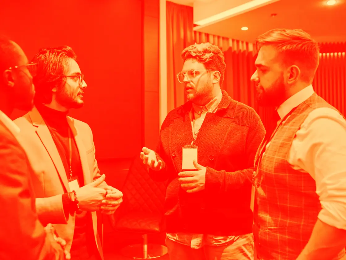 Working the room at a San Diego industry event, fire-and-creme duotone